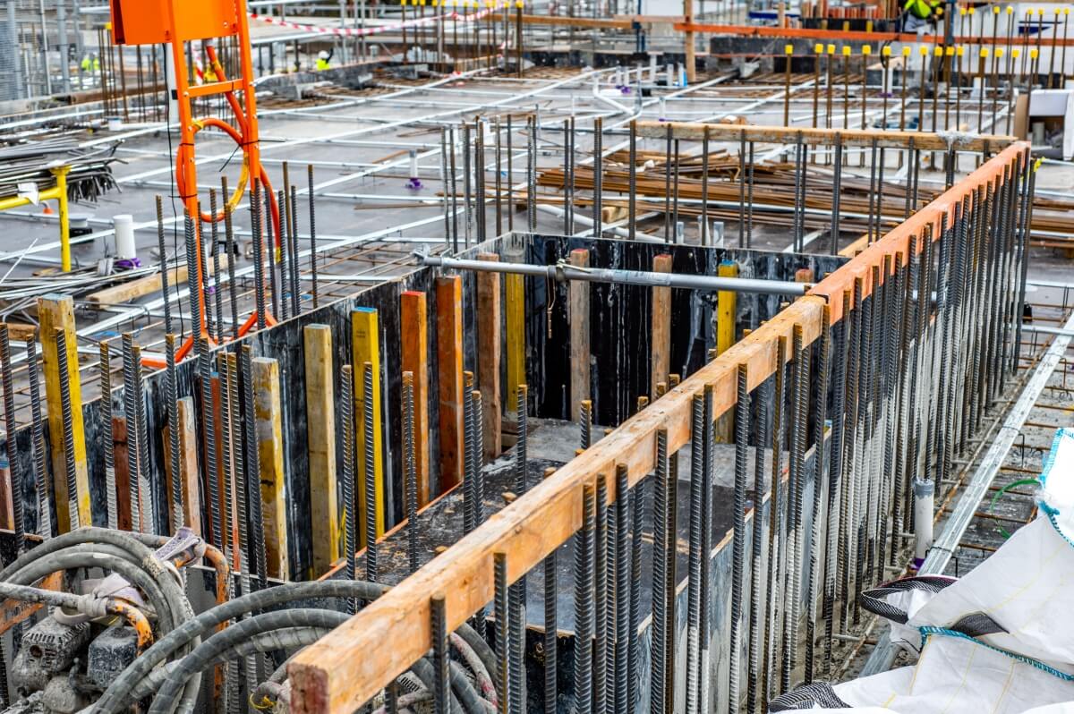 Place budowy z widoczną sklejką szalunkową.